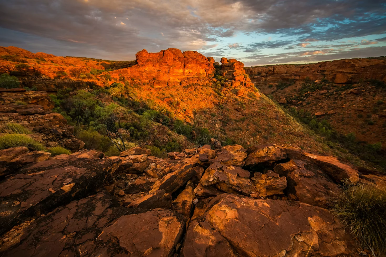 Sunlit red rock walls and rugged ridges in an Australian canyon
