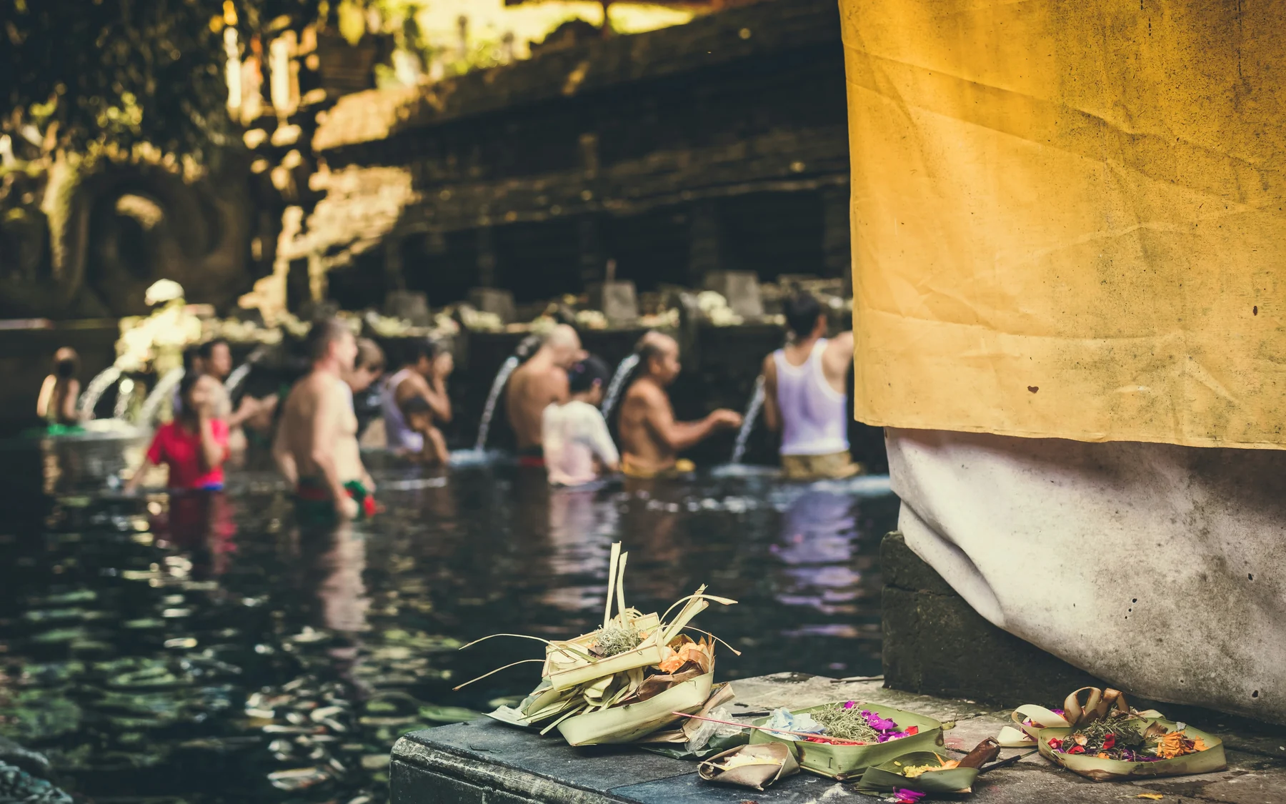 Offerings beside the purification pools at Tirta Empul Temple in Bali