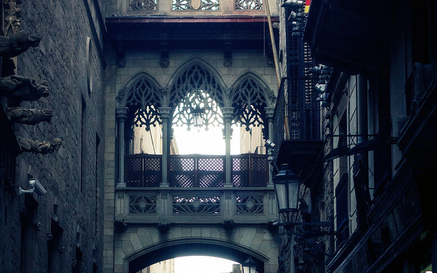 An ornate stone bridge spanning a narrow lane in Barcelona’s Gothic Quarter