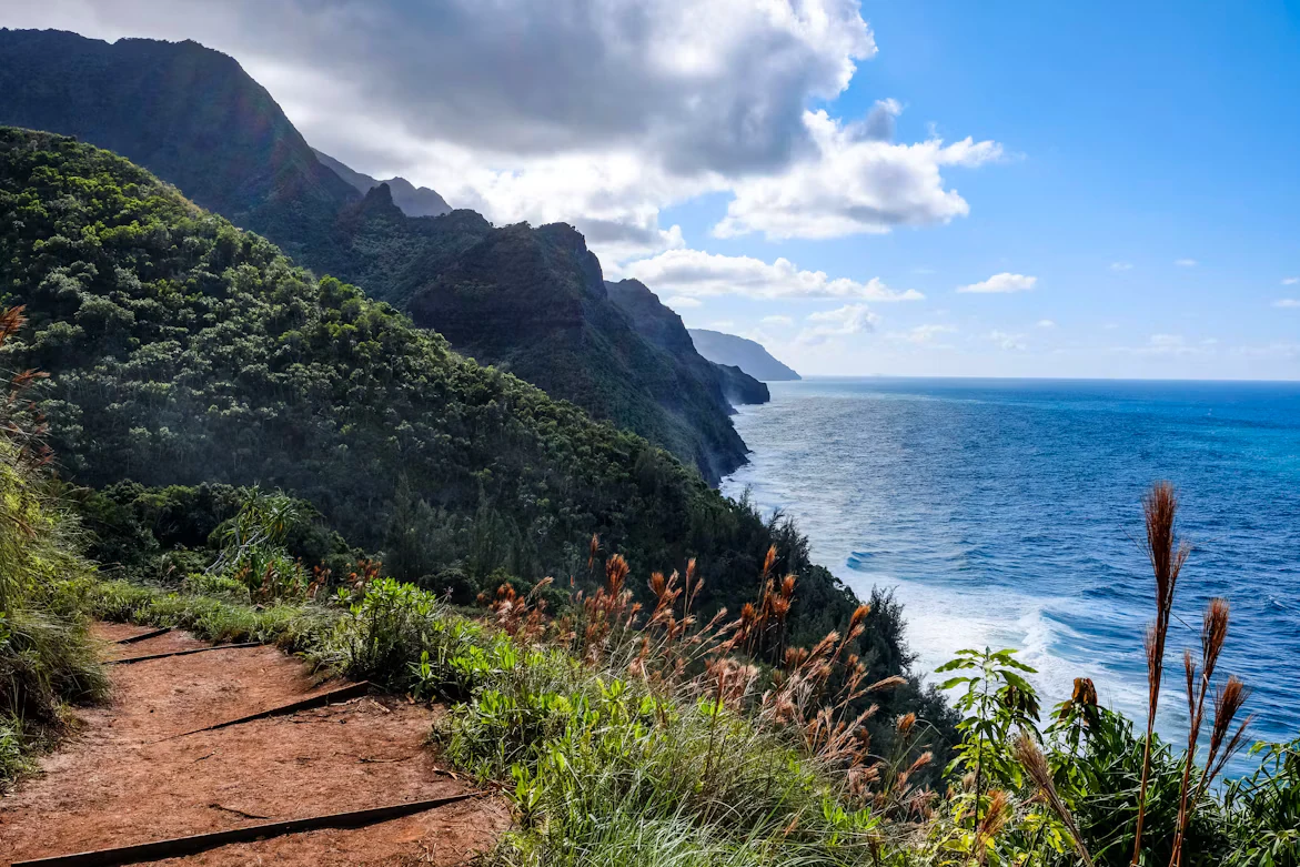 A coastal trail overlooking the mountains and ocean on Kauaʻi