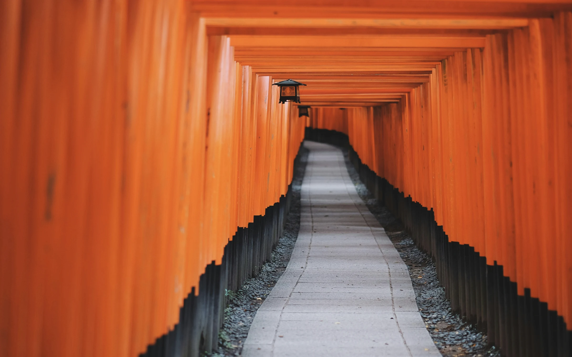 Vermilion torii gates lining a stone path at Fushimi Inari Taisha in Kyoto