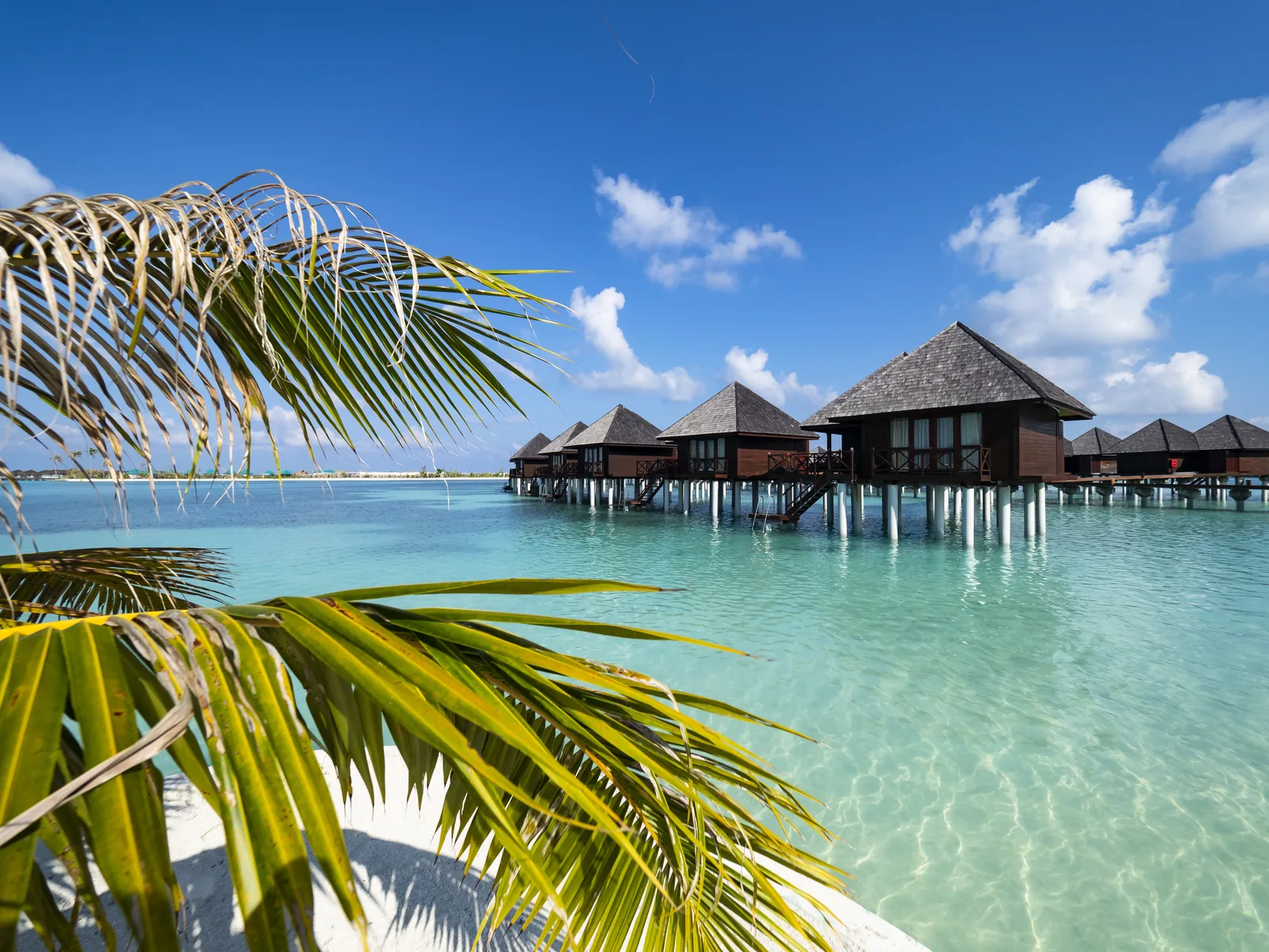 Overwater villas and clear turquoise water in the Maldives