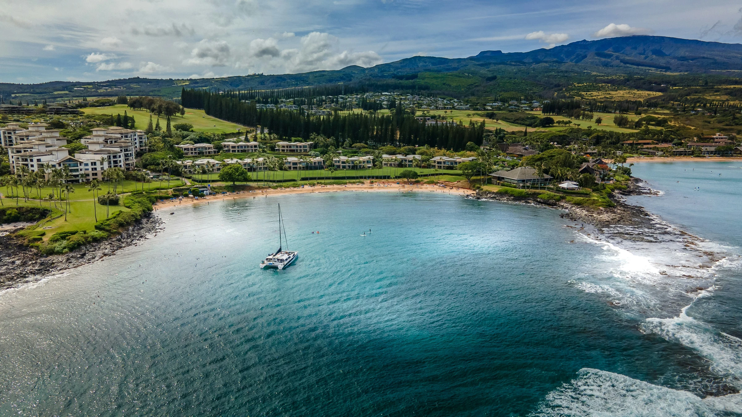 A sailboat anchored in a sheltered Maui bay