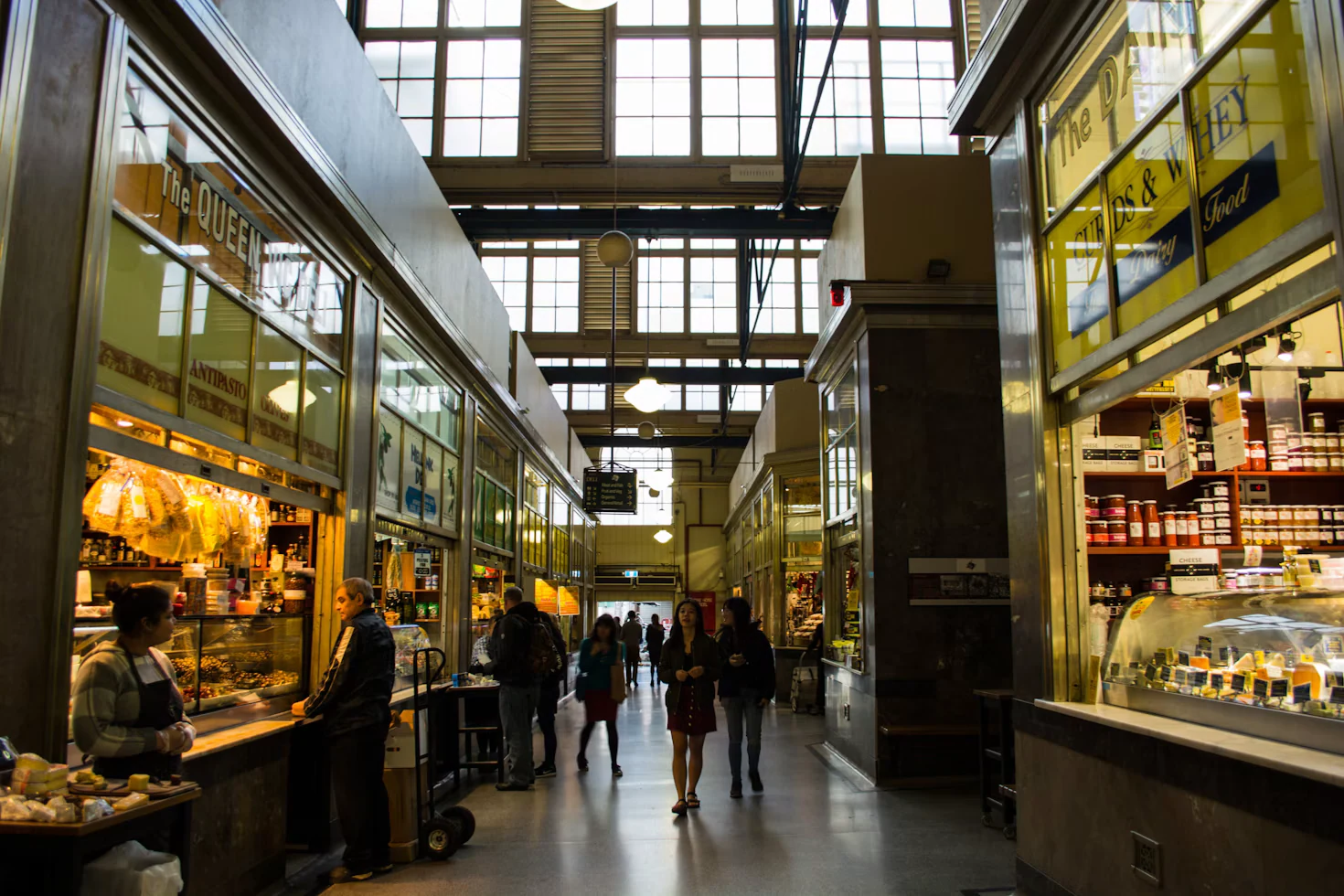 Shoppers browsing food stalls inside a covered Melbourne market