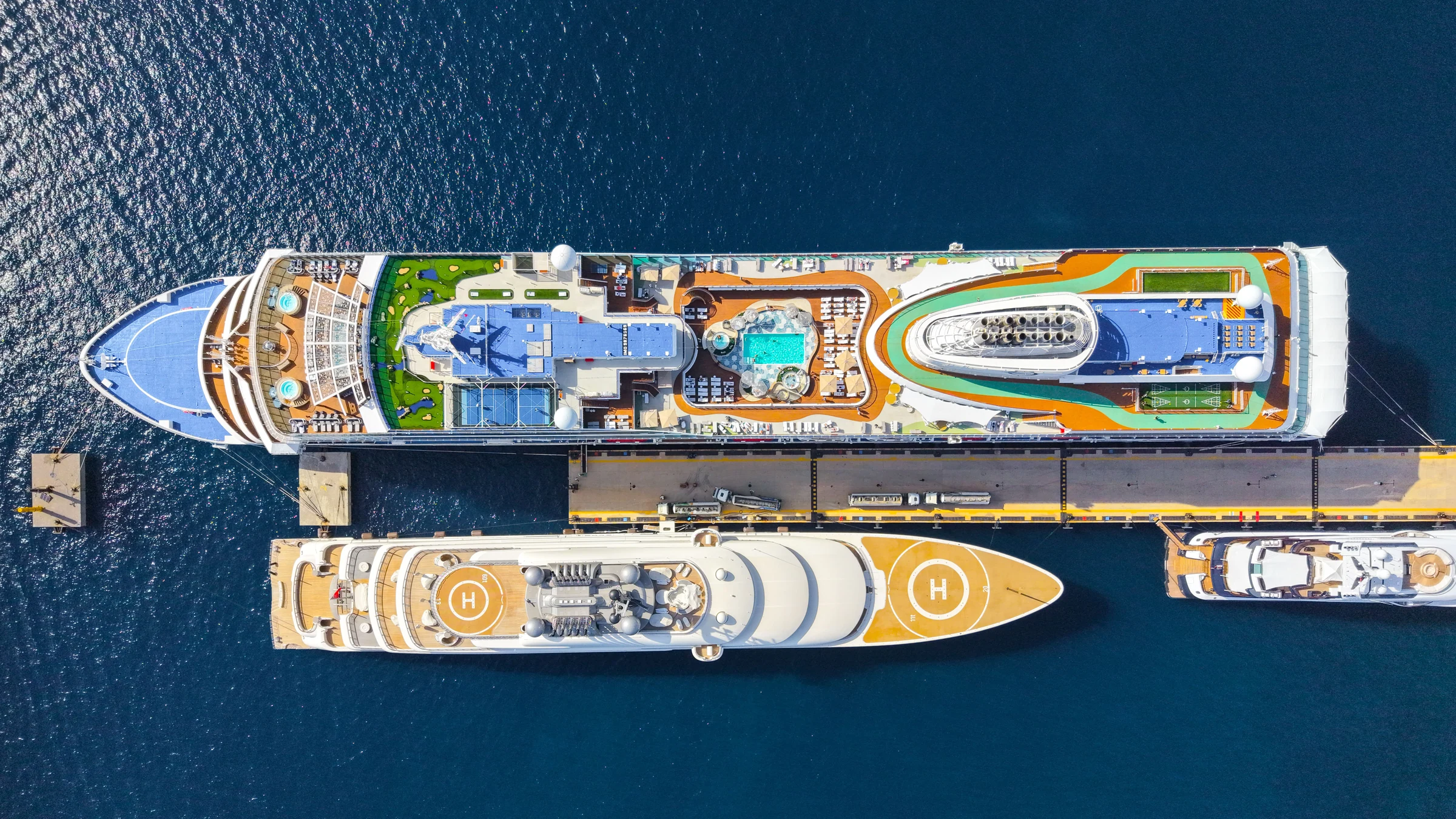Aerial view of a docked cruise ship and its open decks