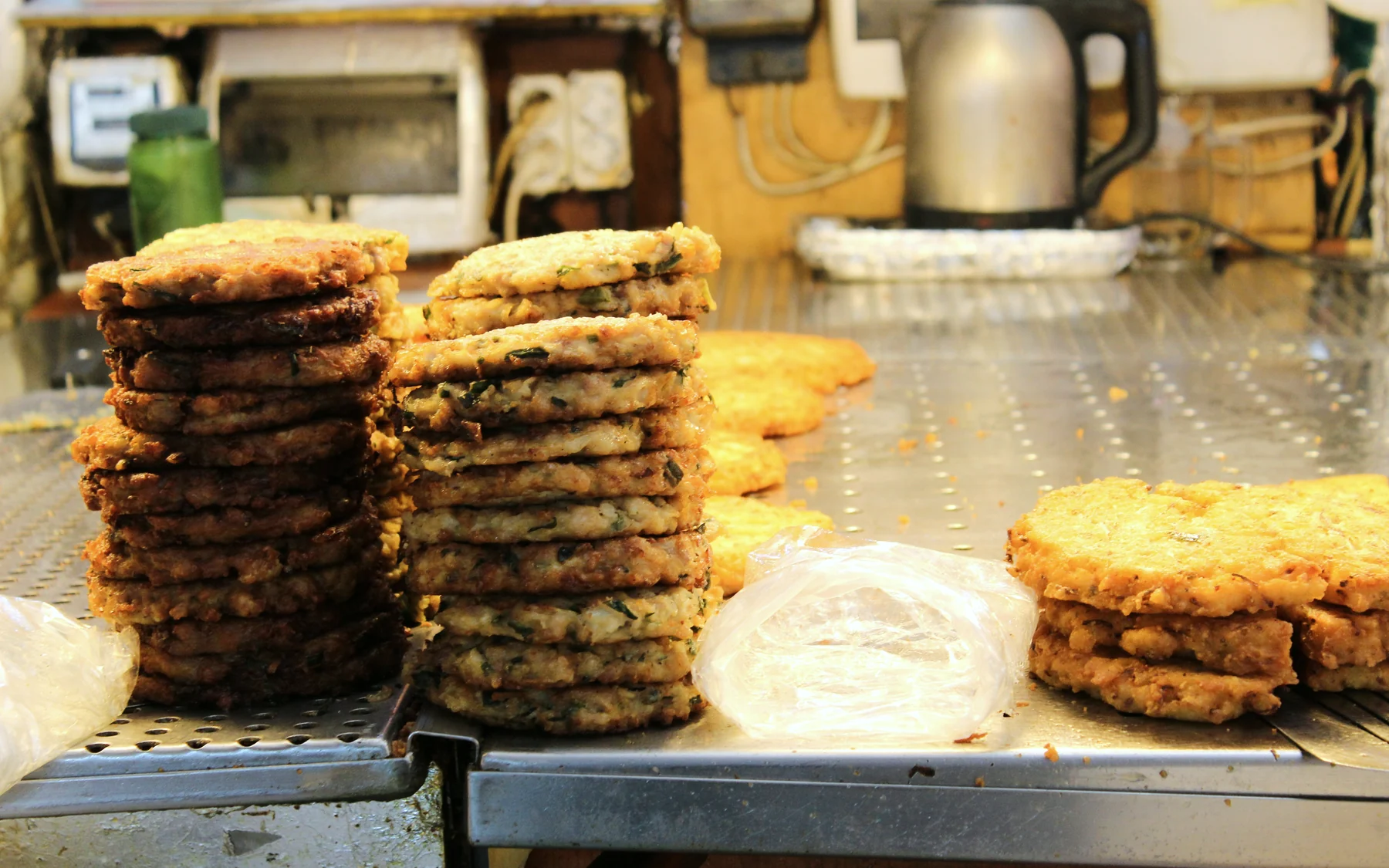 Stacks of savory Korean pancakes at Gwangjang Market in Seoul