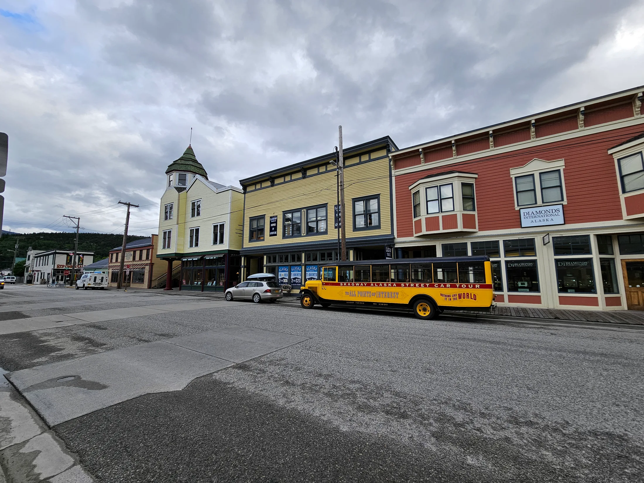 Historic buildings and a yellow street tour vehicle in Skagway