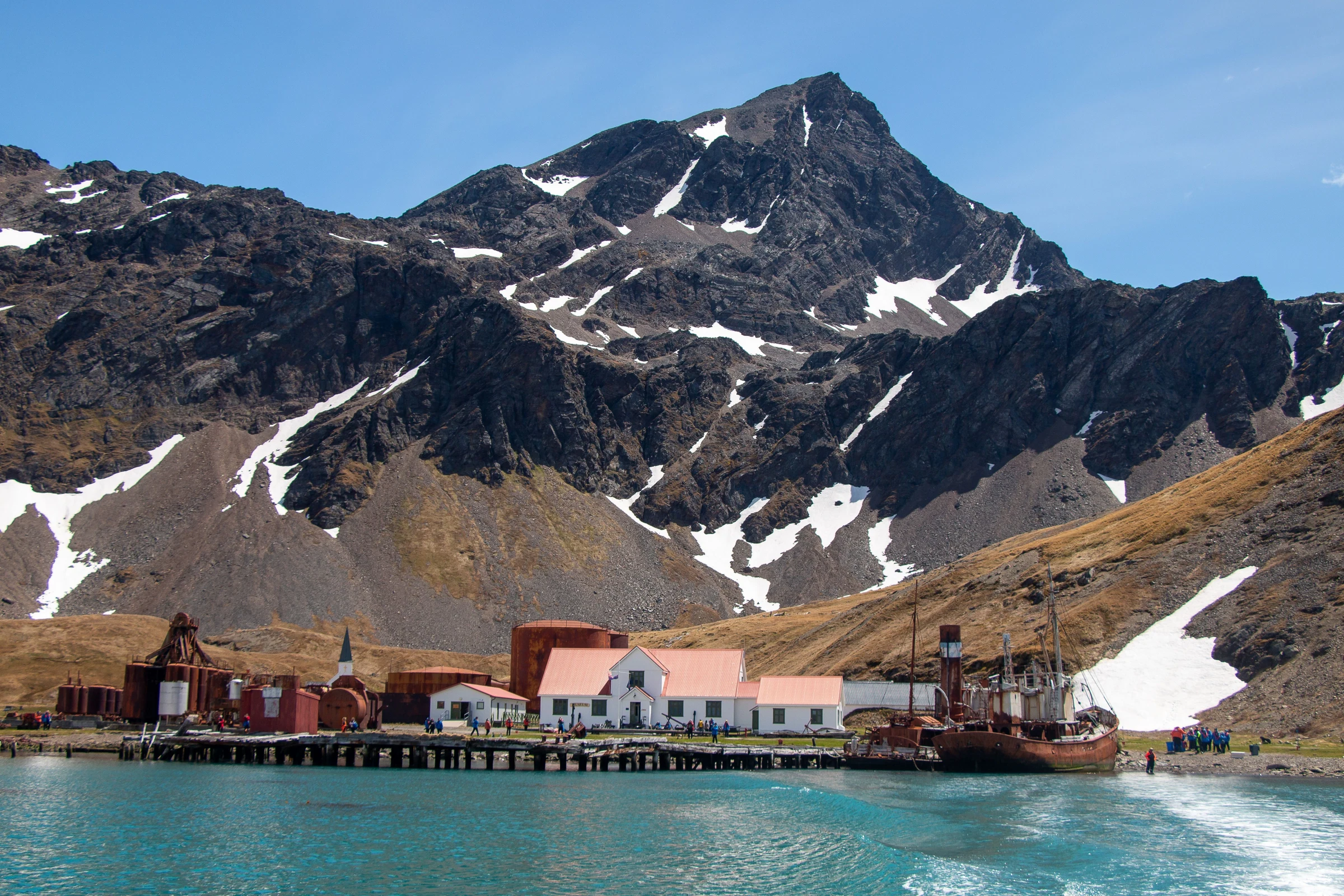 Historic waterfront buildings and a former whaling vessel at Grytviken, South Georgia