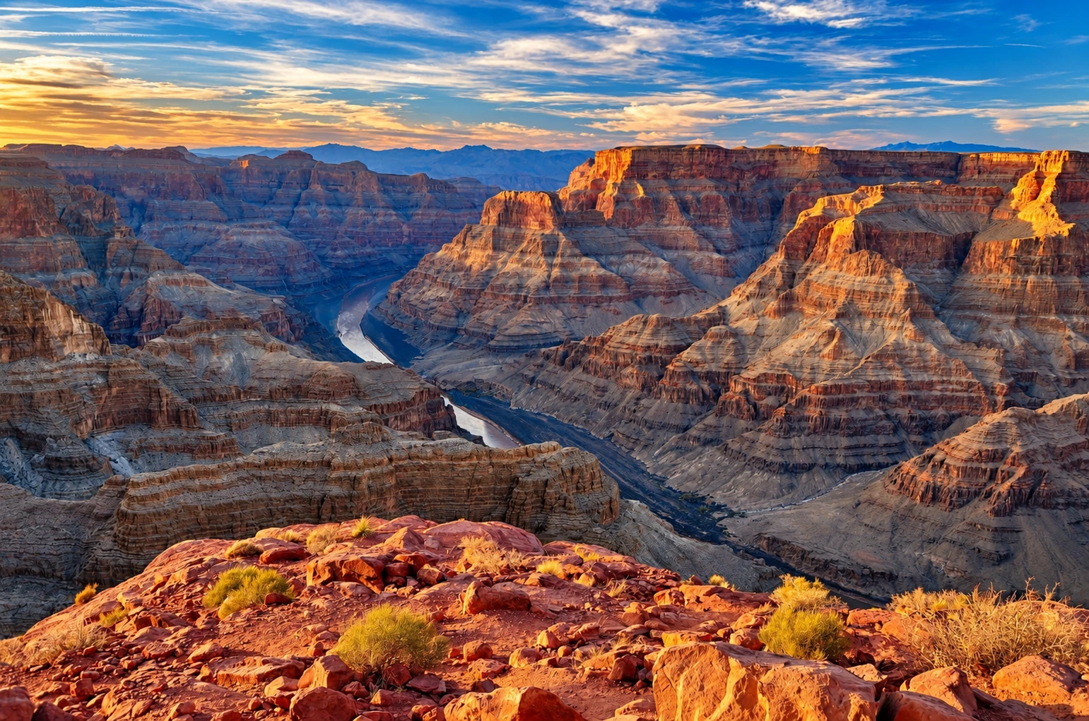 Grand Canyon rock formations and the Colorado River in warm sunlight