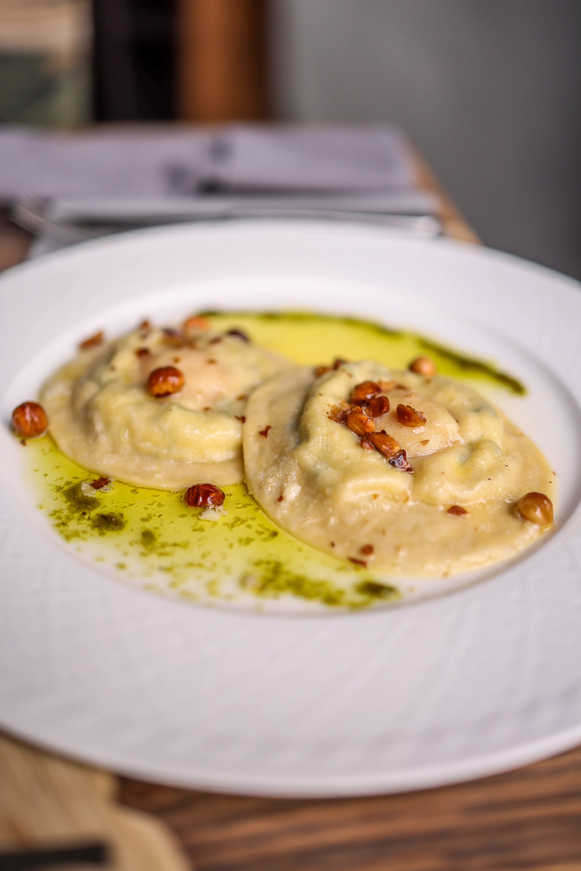Pāua ravioli served with a green herb sauce in Wellington