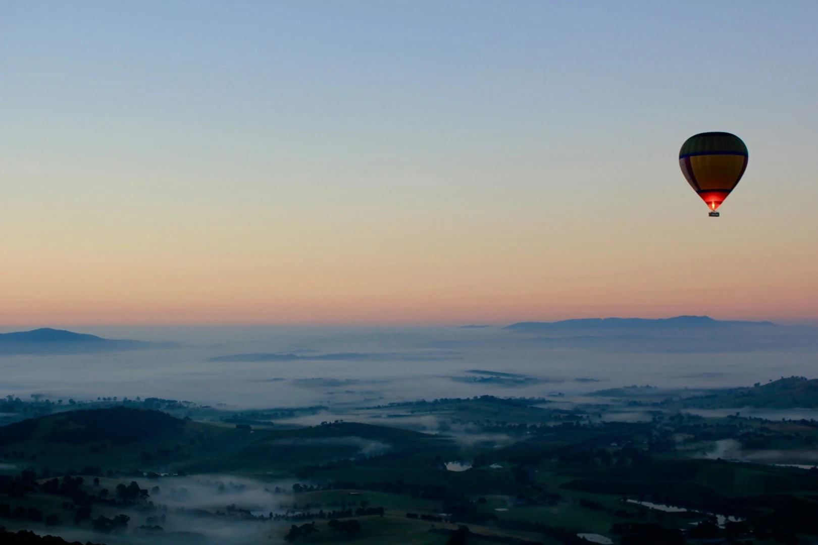 Hot-air balloon above the misty Yarra Valley at dawn