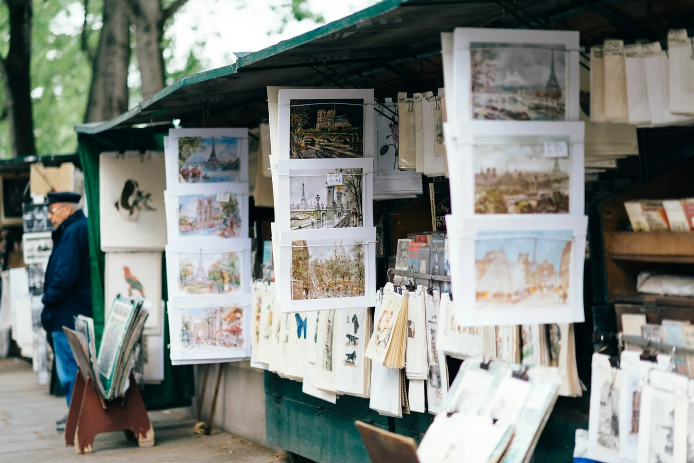 Prints and books at a green riverside stall
