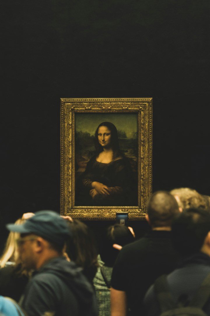 The Mona Lisa in its gilded frame at the Louvre