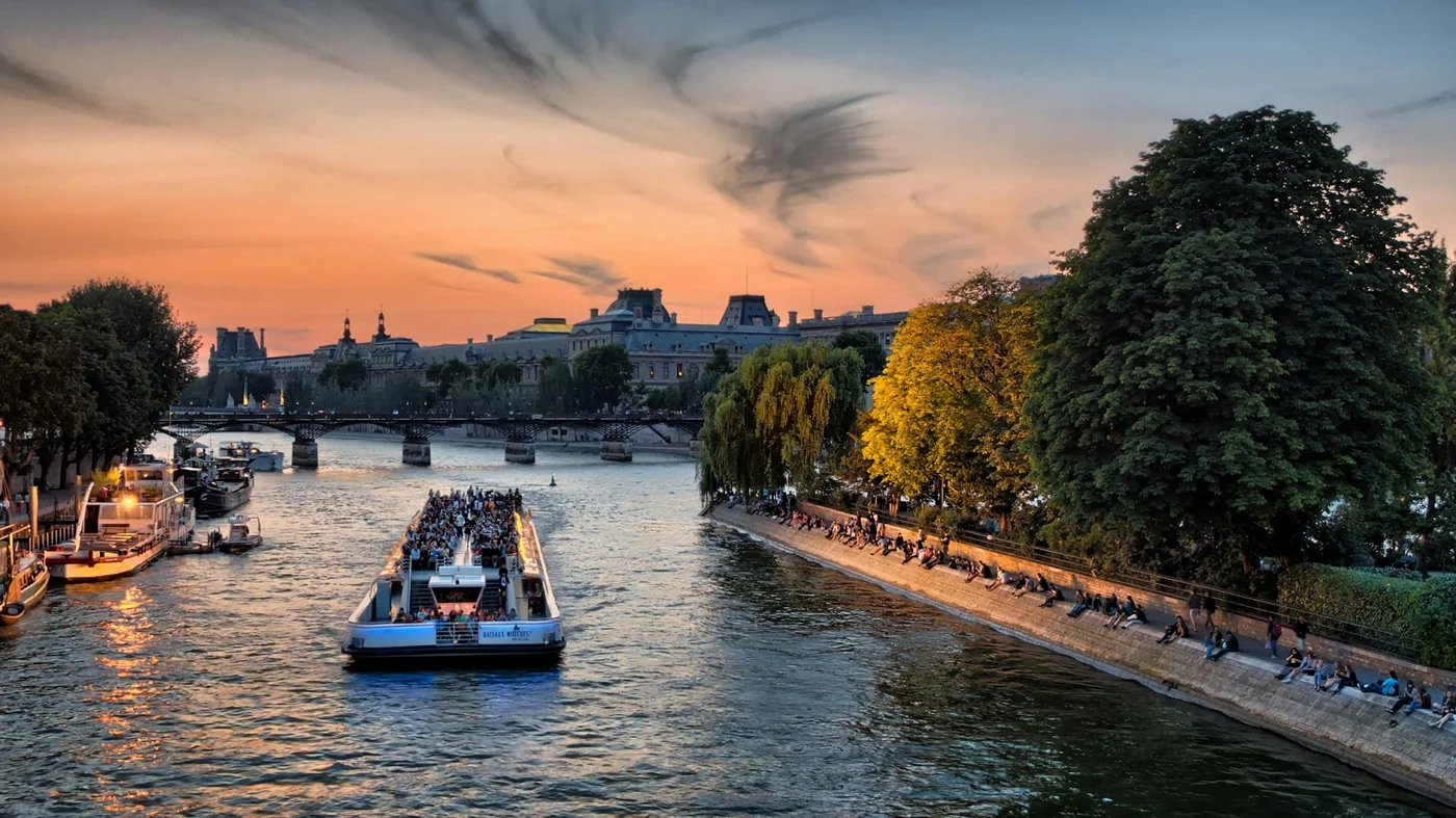 A sightseeing boat on the Seine at sunset