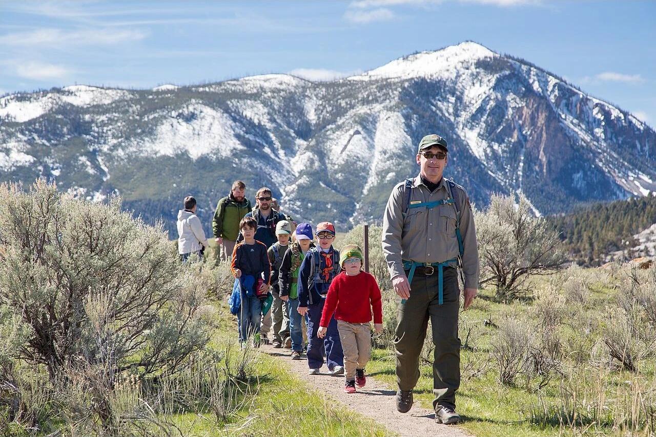 A National Park Service ranger leading children on a hike near Mammoth Hot Springs.