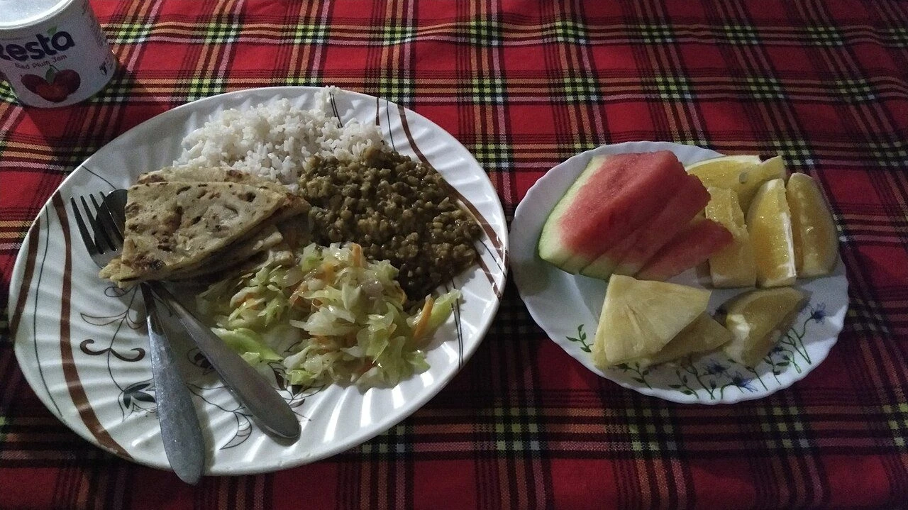 Chapati, rice, dal and fruit served at a dinner in the Maasai Mara, Kenya.