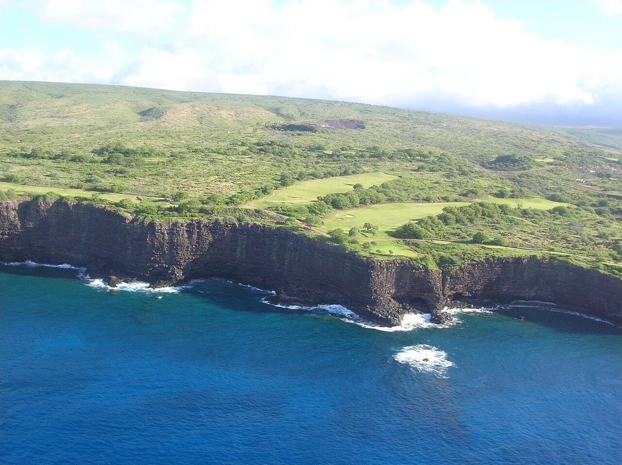 Manele golf course fairways above ocean cliffs on Lanai