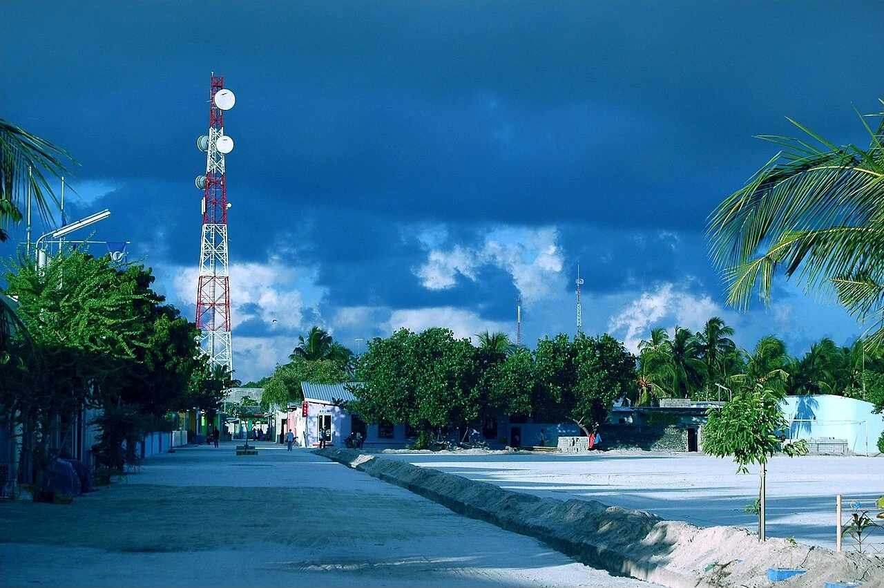 Street, low buildings and palms on Maafushi island