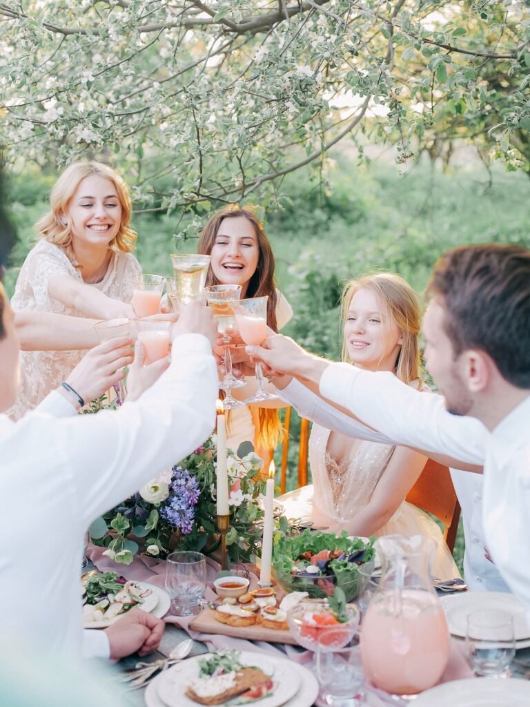 Friends raising glasses around an outdoor garden table